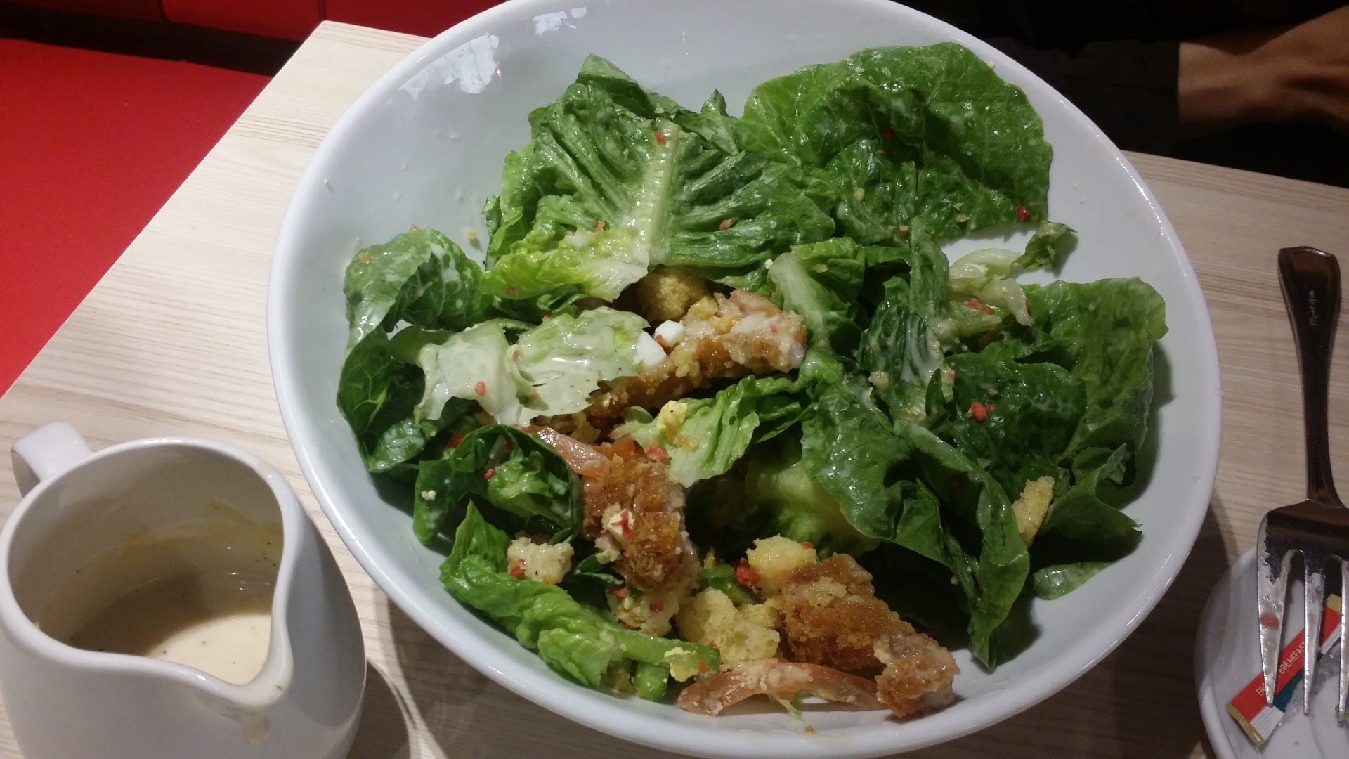 Caesar salad with breaded chicken.