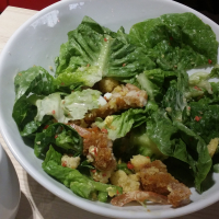 Caesar salad with breaded chicken.